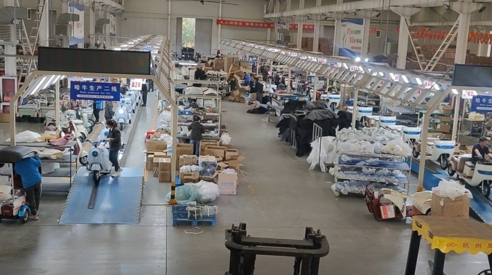 Assembly line with workers at different stations